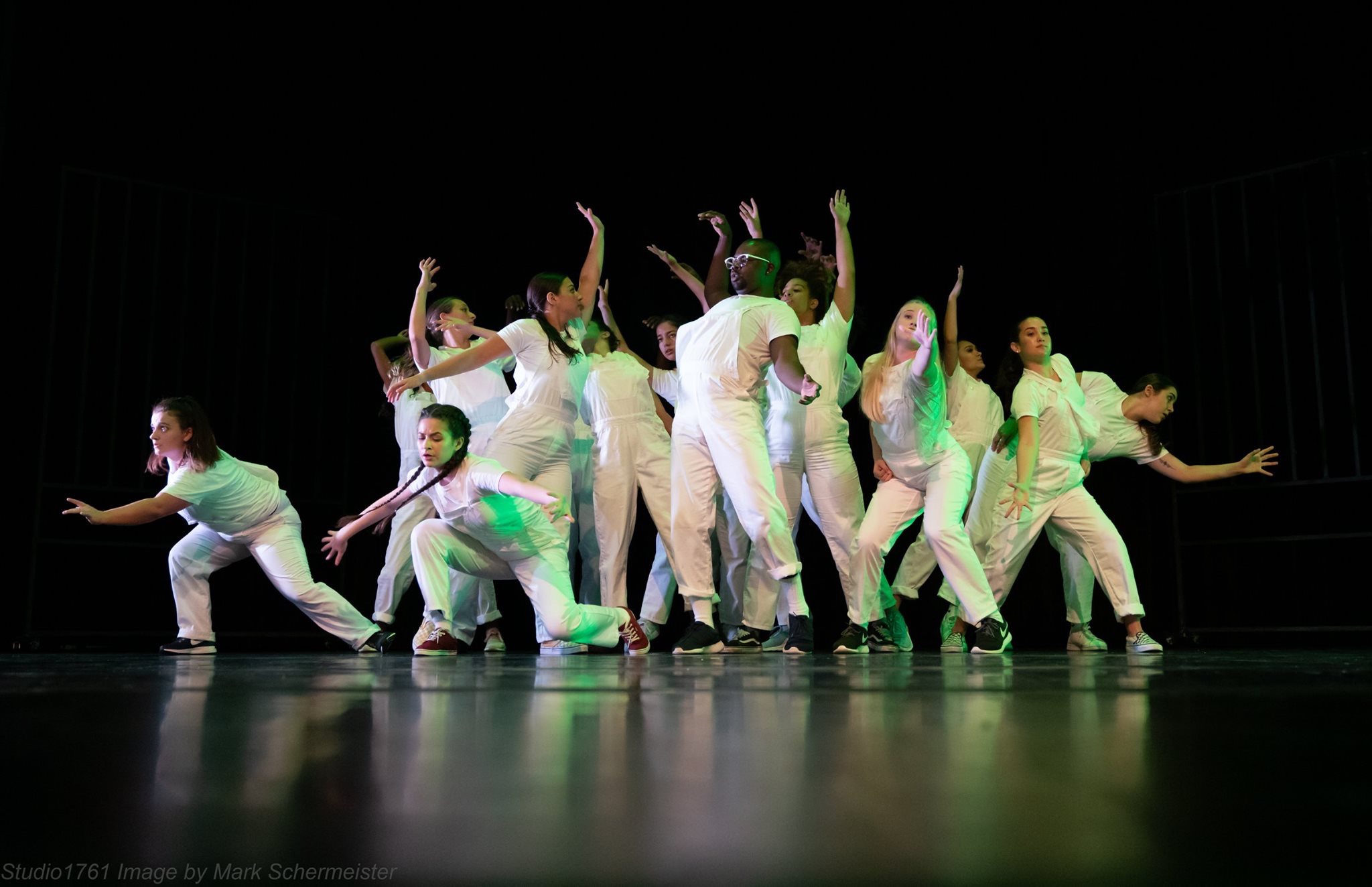 group of dance students performing on stage