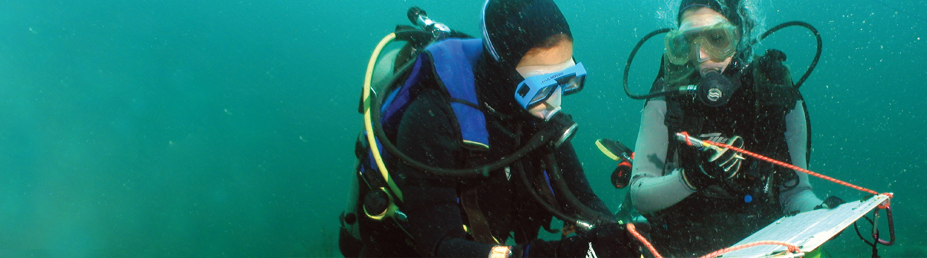 two students conducting underwater research