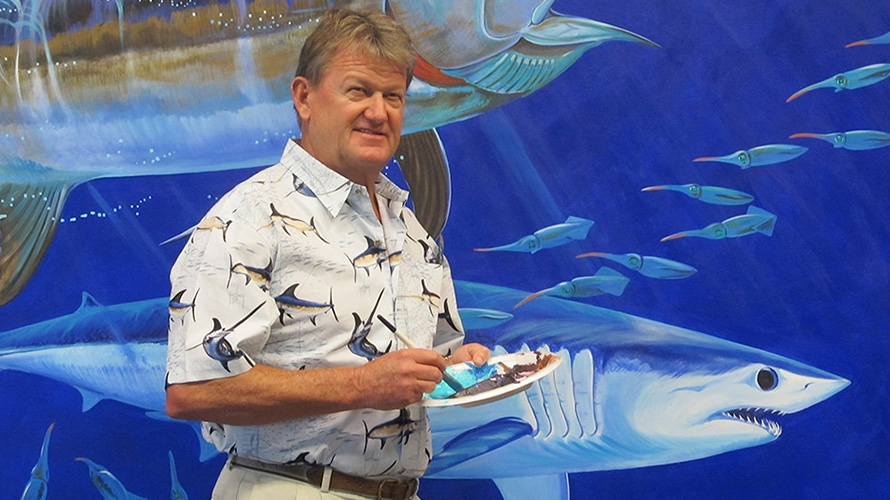 Guy Harvey holding notepad