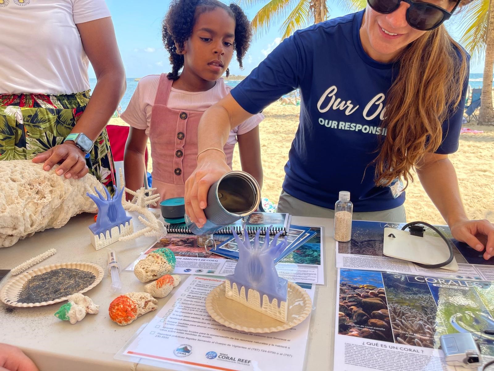 Fellow showcasing work to a child
